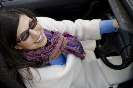 Stylish woman driving a convertible car in the Fallの写真素材