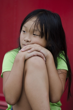 Cute young Asian girl thinking over some issuesの写真素材