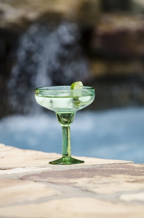 Margarita waiting by the side of the poolの写真素材