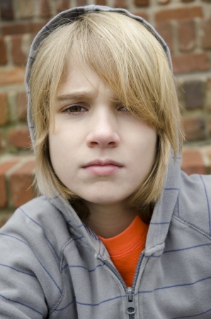 Angry young man wearing a hoodie and staring at meの写真素材