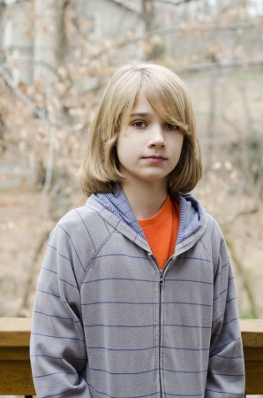 young preteen boy standing still for the photoの写真素材