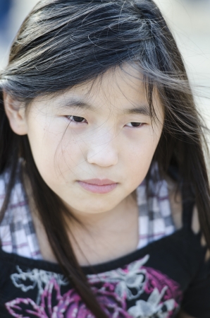 Young Asian girl upset and thinking over a situationの写真素材