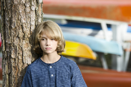 boy isolating himself from others while at campの写真素材