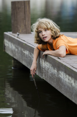 calling out to a boy who is stirring the waterの写真素材