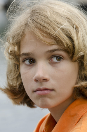 young boy looking over at something that got his attentionの写真素材