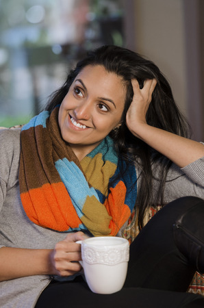 Pretty Indian woman sitting back and relaxingの写真素材