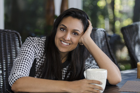 pretty young Indian woman enjoying spending time with youの写真素材