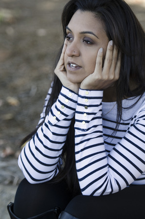 Attractive young Indian woman with her head in the cloudsの写真素材