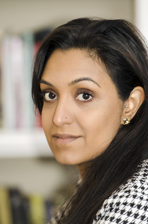 Attractive young and fashionable Indiam woman stares into the lensの写真素材