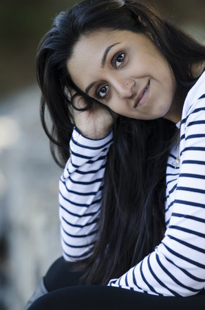 Beautiful Indiam woman waiting on a friendの写真素材