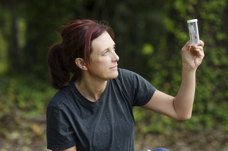 chemist looking closely at the result of her experimentの写真素材