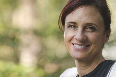 Happy lady enjoying a beautiful day outsideの写真素材