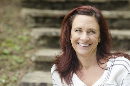 Attractive redhaired lady looking right at youの写真素材