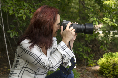 professional photographer setting up a shot outsideの写真素材