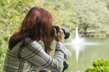 Watching a photographer concentrate on her subjectの写真素材
