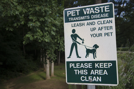 Pet waste sign reminding owner to clean up after their petsの写真素材