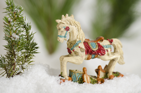 Antique Christmas ornimental horse in the snowの写真素材