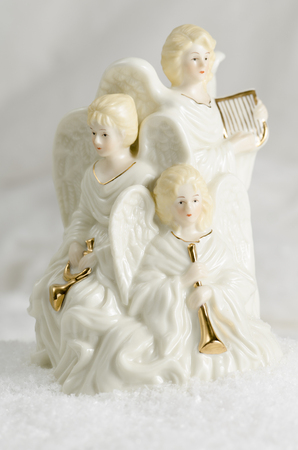 Three ceramic Christmas angels and their onstrumentsの写真素材