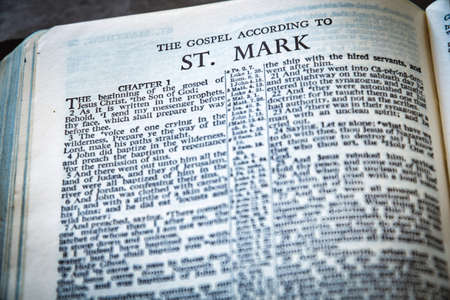 Close up of Holy Bible page, shallow depth of field with focus on book chapter, heading, St Markの写真素材