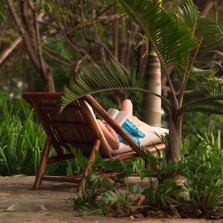 Malpais in Costa Rica,Woman on a lounge chair readingの写真素材