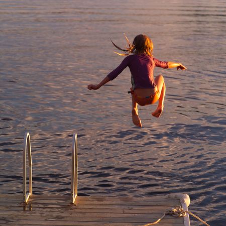 Lake of the Woods Ontario Canada,Girl jumping into lakeの写真素材