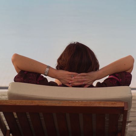 Parrot Cay,Woman relaxing in a chaise lounge chairの写真素材