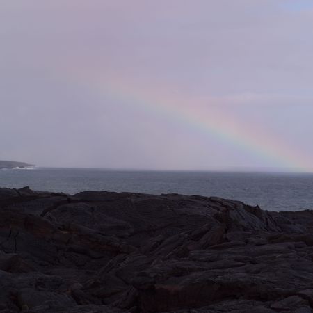 A rainbow across the skyline of Hawaii Volcanoes National Park.の写真素材