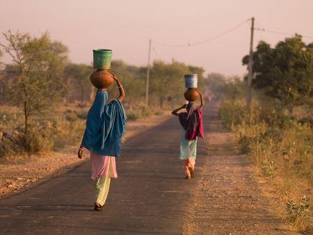 Rajasthan, India - women balancing containers on their headsの写真素材