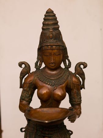 Carved figurnie holding a dish in Jewtown, Cochin, Kerala, Indiaの写真素材