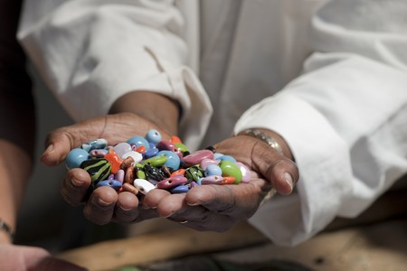 Hands holding colorful beadsの写真素材