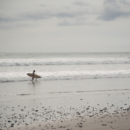 Surfer along ocean seashore in Costa Ricaの写真素材