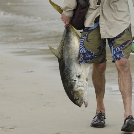 Fisherman holding a fish, Sayulita, Nayarit, Mexicoの写真素材
