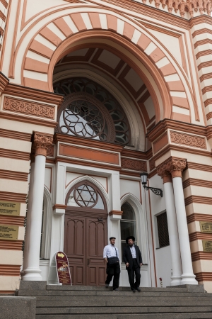 Men moving down steps of the Grand Choral Synagogue, St. Petersburg, Russiaのeditorial素材