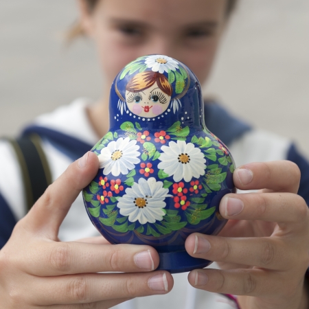Close-up of a girl showing a Russian nesting doll, St. Petersburg, Russiaの写真素材