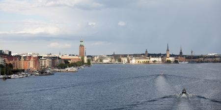Boats moving in the bay with buildings in the background, Stockholm Town Hall, Riddarfjarden, Stockholm, Swedenのeditorial素材