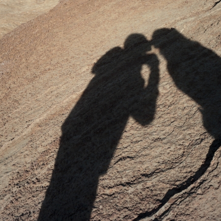 Shadow of a couple on a rock, Horseshoe Bend, Glen Canyon National Recreation Area, Arizona-Utah, USAの写真素材
