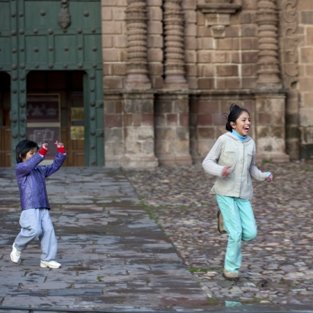 Boy playing with his sister in a market, Plaza de Armas, Cuzco, Peruのeditorial素材