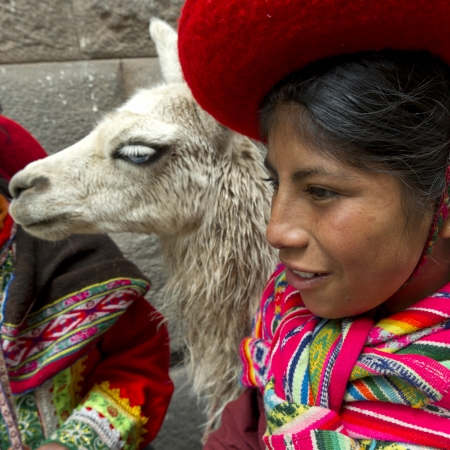 Close-up of a girl with a llama (Lama glama), Cuzco, Peruのeditorial素材