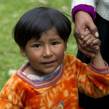 Portrait of a girl holding her mother's hand, Sacred Valley, Cusco Region, Peruのeditorial素材