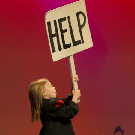 Girl holding a help sign banner at Hughes American Family Theater, Branson, Taney County, Missouri, USAのeditorial素材