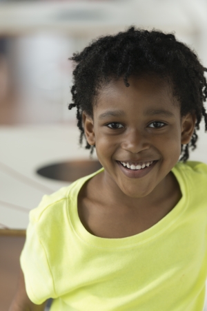 Portrait of a school age girl smiling, Chicago, Cook County, Illinois, USAの写真素材