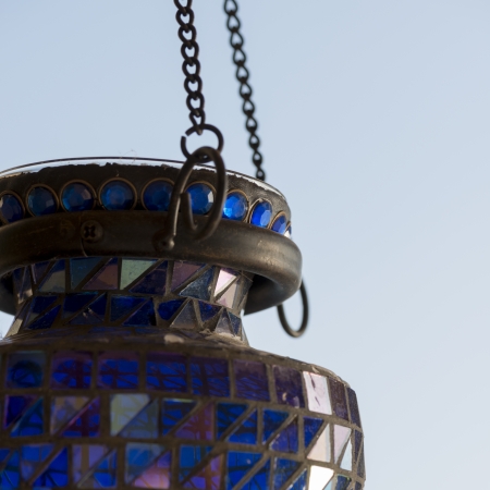 Close-up of a decorative lantern hanging from a metal chain, Lake of The Woods, Ontario, Canadaの写真素材