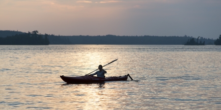 Person boating in the Lake Of The Woods, Keewatin, Ontario, Canadaの写真素材