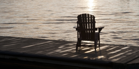 Adirondack chair on a dock at dawn, Lake Of The Woods, Keewatin, Ontario, Canadaの写真素材