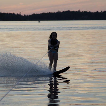 Girl waterskiing in a lake, Lake of The Woods, Keewatin, Ontario, Canadaの写真素材