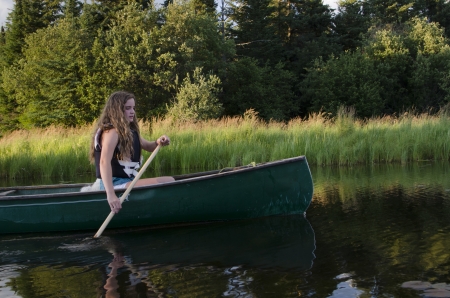 Girl boating in a lake, Lake of The Woods, Keewatin, Ontario, Canadaのeditorial素材