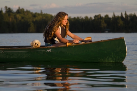 Girl boating in a lake, Lake of The Woods, Keewatin, Ontario, Canadaのeditorial素材