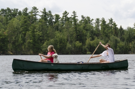 Woman rowing a boat with her daughter, Lake of The Woods, Keewatin, Ontario, Canadaのeditorial素材