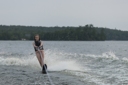 Girl waterskiing in a lake, Lake of The Woods, Keewatin, Ontario, Canadaの写真素材