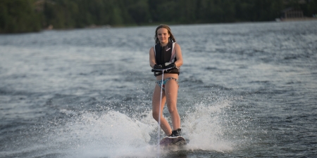 Girl waterskiing in a lake, Lake of The Woods, Keewatin, Ontario, Canadaの写真素材